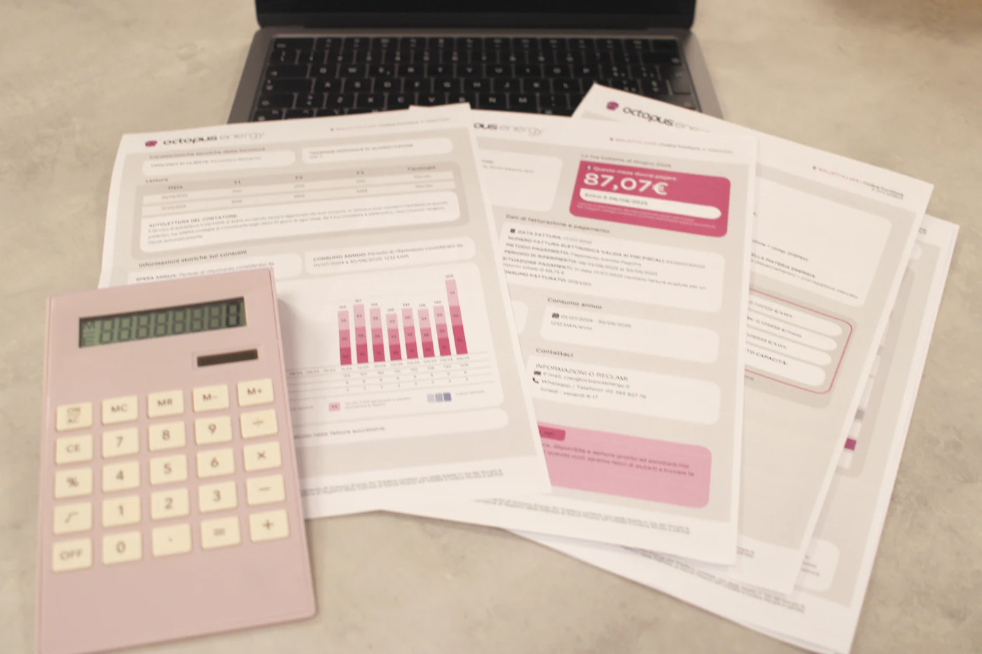 Invoices and statements with a calculator and laptop on a desk, representing payables and receivables work